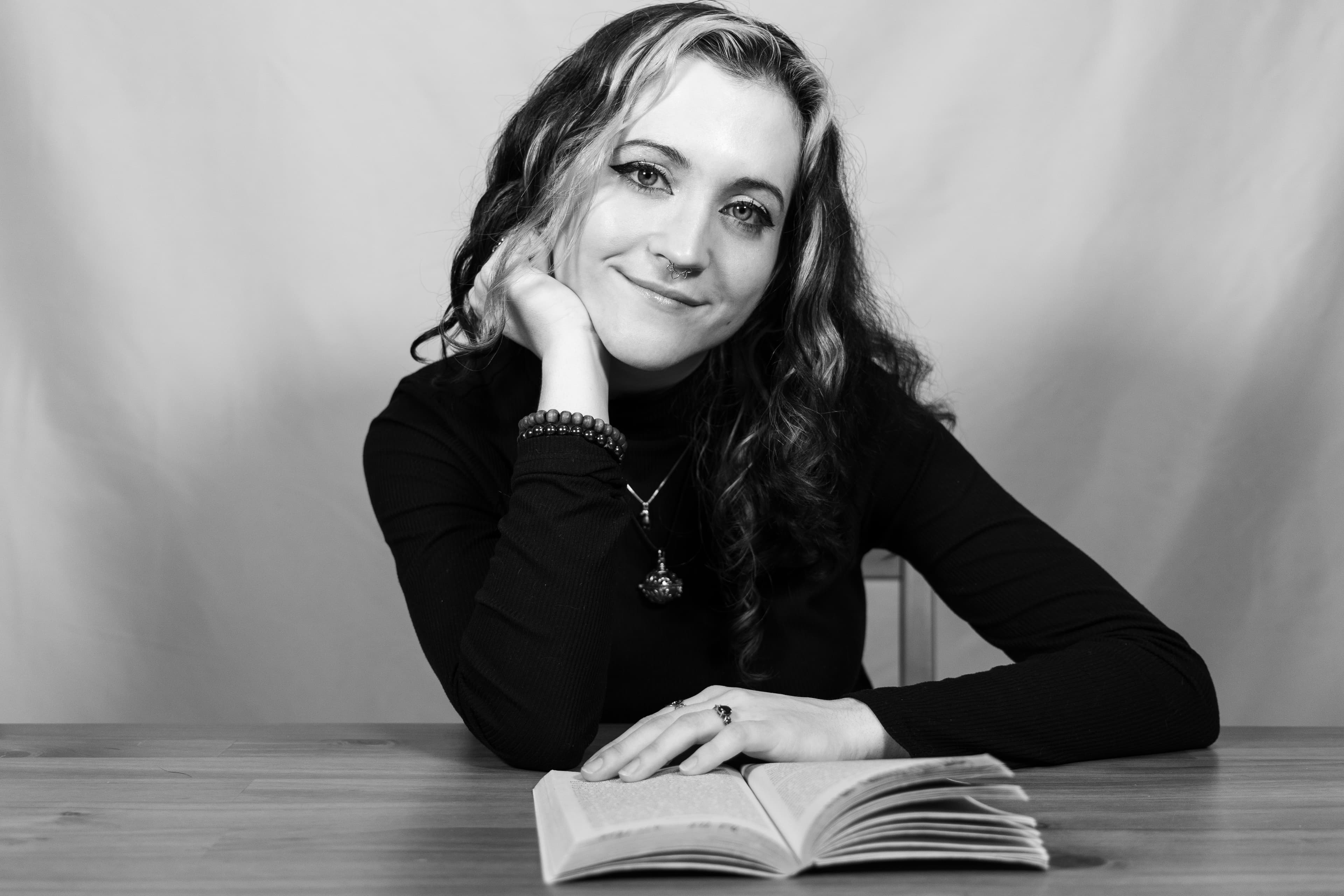 Woman smiling with an open book