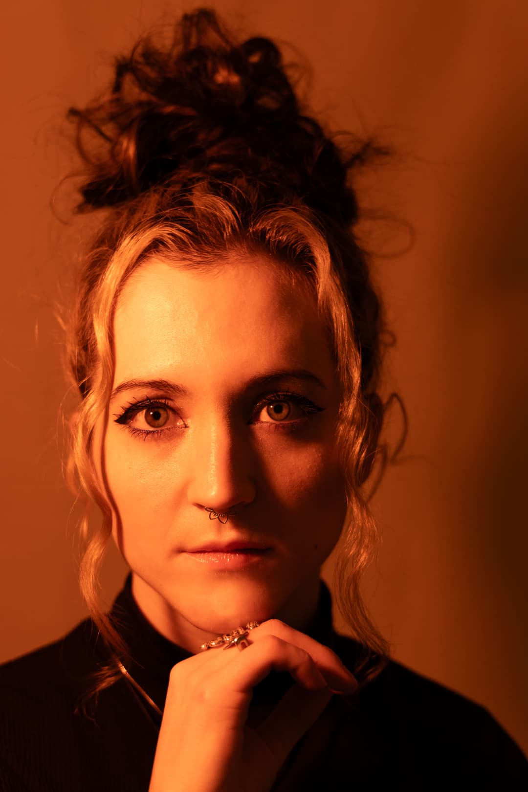 Headshot of a person in scarlet light.